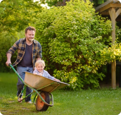 little boy in a wheel barrow